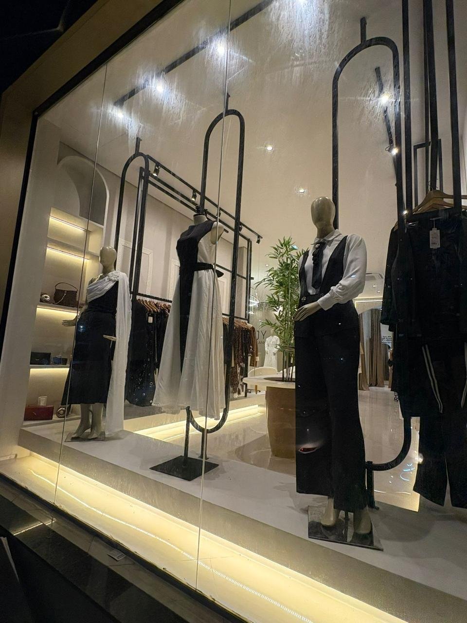 Vitrine iluminada com manequins e estrutura metalica preta